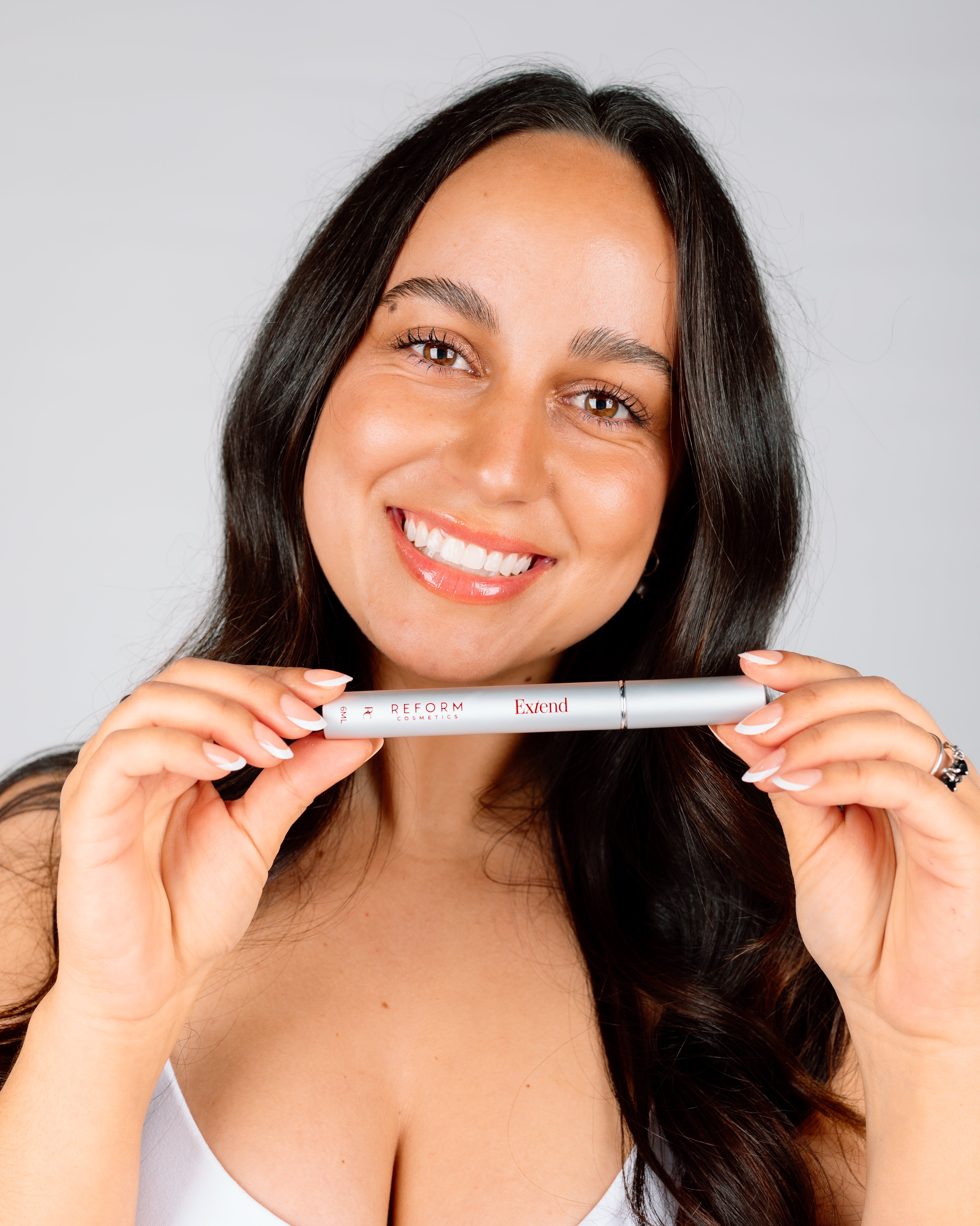 Women wears reform cosmetics lash serum infused mascara.